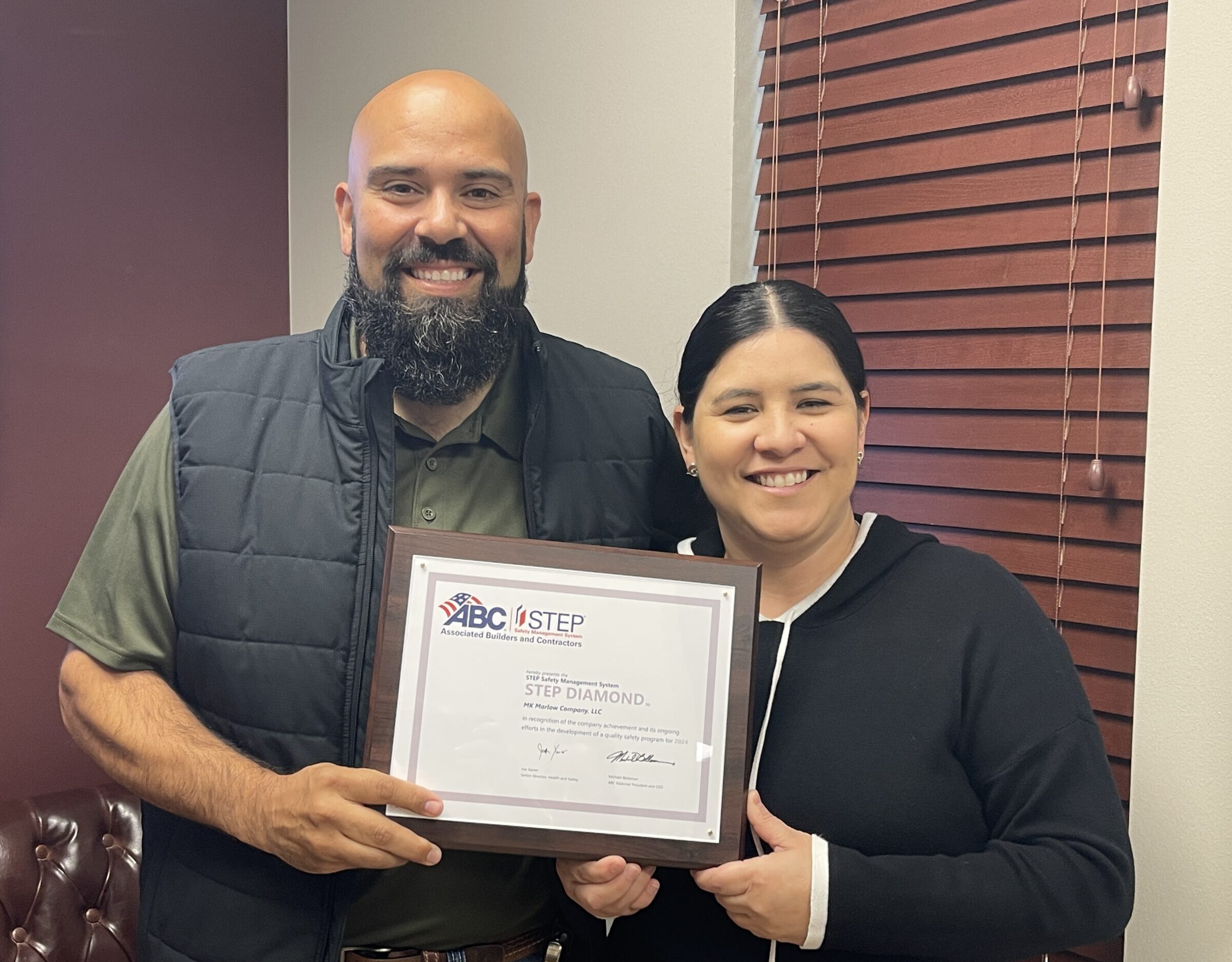 AJ and Angela holding the 2024 STEP Award